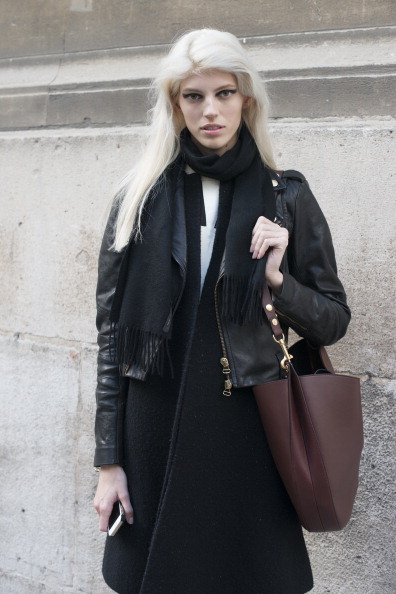 PARIS, FRANCE - JANUARY 19: Model Devon Windsor wears a Balmain leather jacket, Oak coat, Opening Ceremony top, Marc Jacobs scarf, Helmut Lang trousers and Celine bag day 5 of Paris Mens Fashion Week Autumn/Winter 2014, on January 19, 2014 in Paris, France. (Photo by Kirstin Sinclair/Getty Images)
